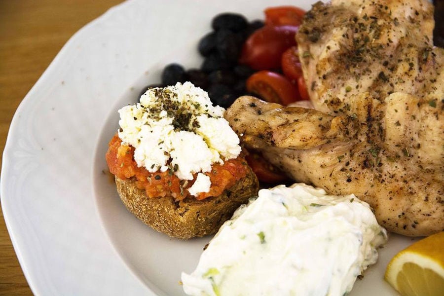 close-up of plate with bread, cooked meet, cheese at Cretan Brewery restaurant